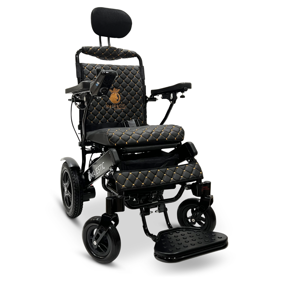 Indulge in the elegance of the ComfyGo MAJESTIC IQ-9000 Auto Recline Remote Controlled Electric Wheelchair, featuring exquisite quilted black and gold upholstery. Equipped with brushless silent motors and a digital joystick controller on the right armrest, this model includes armrests, a headrest, footrests, and proudly displays an embroidered Majestic logo on the seat back.